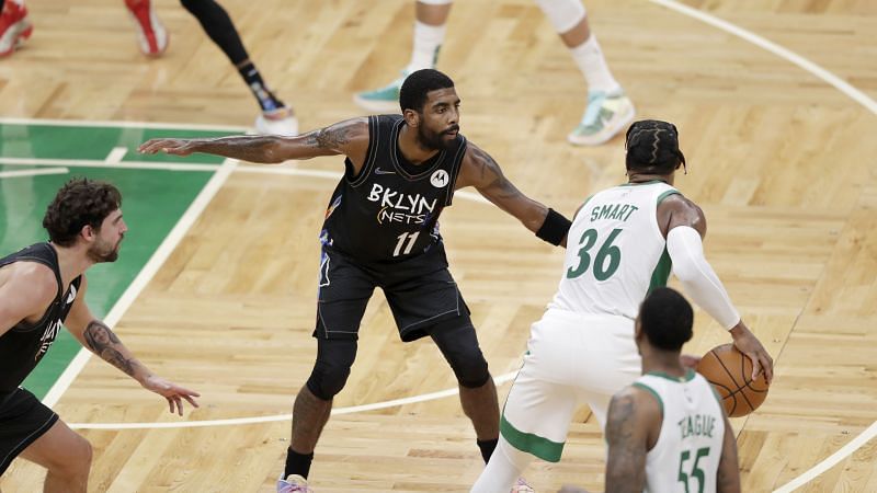 Kyrie Irving (#11) of the Brooklyn Nets defends Marcus Smart (#36) of the Boston Celtics