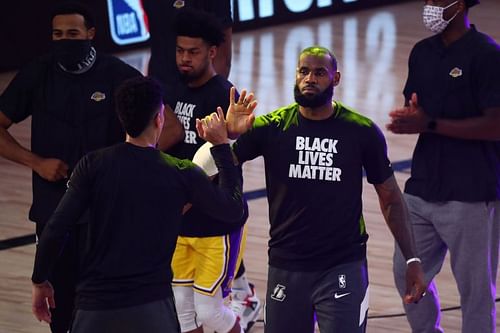 LeBron James #23 of the Los Angeles Lakers is greeted by teammates during player introductions