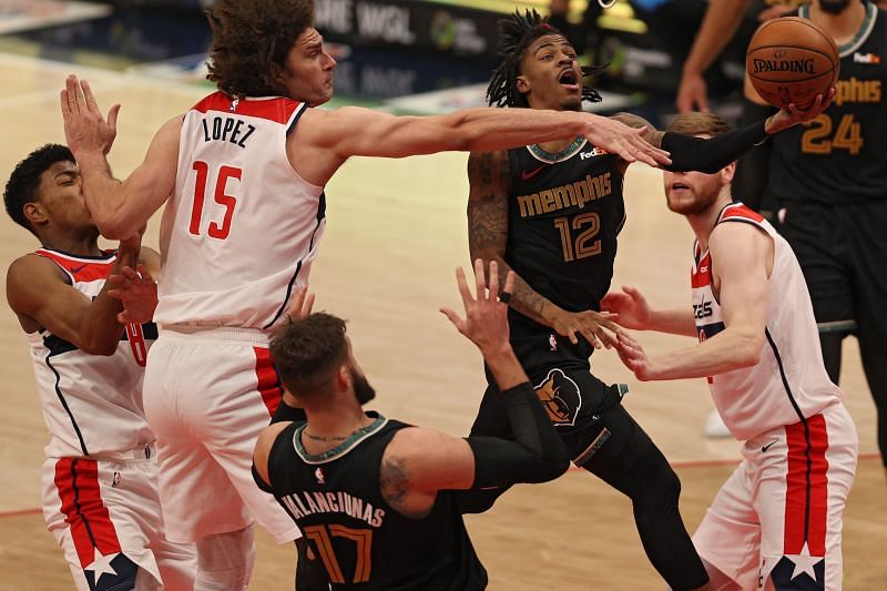 Ja Morant #12 of the Memphis Grizzlies shoots in front of Robin Lopez #15 of the Washington Wizards 