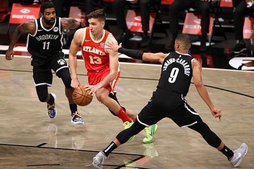 Bogdan Bogdanovic (#13) splits two defenders on the drive Brooklyn Nets v Orlan