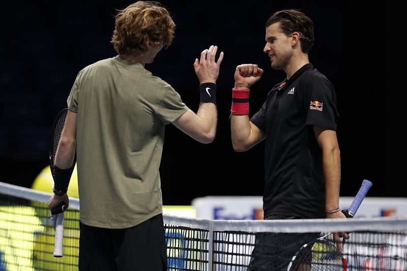 Andrey Rublev (L) and Dominic Thiem embrace at the net