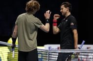 Andrey Rublev (L) and Dominic Thiem embrace at the net