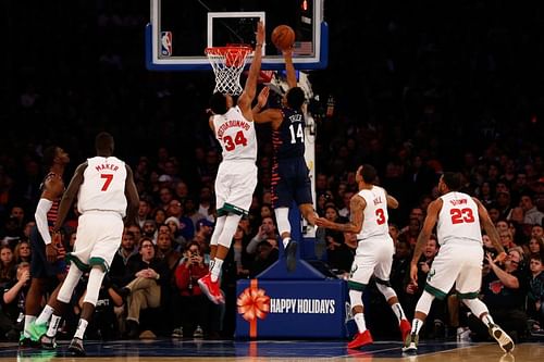 Giannis Antetokounmpo #34 of the Milwaukee Bucks blocks a shot by Allonzo Trier #14 of the New York Knicks