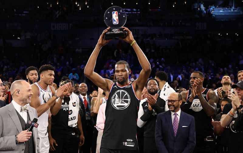 Kevin Durant #35 of the Golden State Warriors and Team LeBron celebrates with the MVP trophy