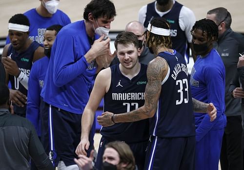 Luka Doncic #77 of the Dallas Mavericks celebrates with Willie Cauley-Stein #33 of the Dallas Mavericks. (Photo by Tom Pennington/Getty Images)