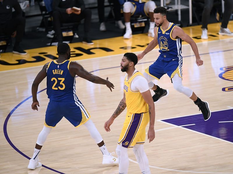 Stephen Curry of the Golden State Warriors celebrates with Draymond Green.