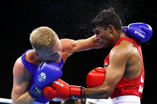 Manish Kaushik of India (red) at the Gold Coast 2018 Commonwealth Games in April, 2018