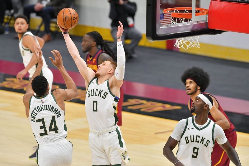 Donte DiVincenzo #0 grabs a rebound over Giannis Antetokounmpo #34 of the Milwaukee Bucks during the fourth quarter against the Cleveland Cavaliers. (Photo by Jason Miller/Getty Images).
