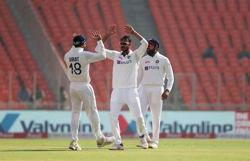 Indian skipper, Virat Kohli, alongside Rohit Sharma, celebrating a wicket with Axar Patel.