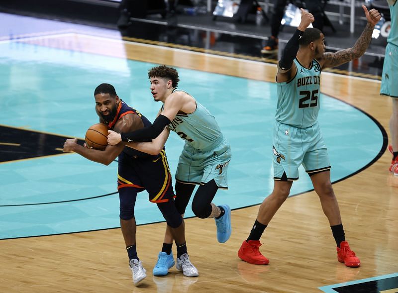 Brad Wanamaker #10 of the Golden State Warriors and LaMelo Ball #2 of the Charlotte Hornets battle for possession as P.J. Washington #25 of the Charlotte Hornets calls for a jump ball. 