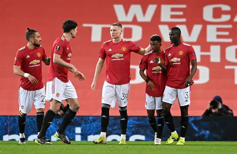 Manchester United players celebrate after opening the scoring against AC Milan