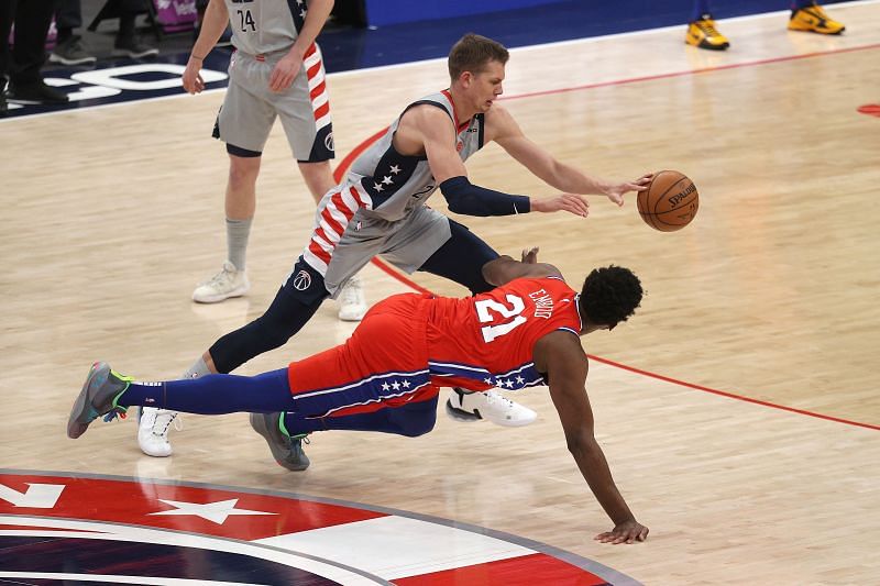 Philadelphia 76ers center #21 Joel Embiid dives for a loose ball