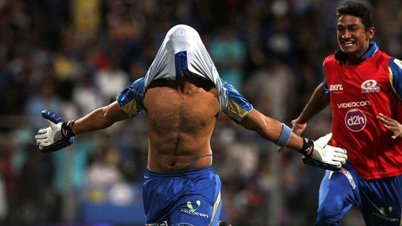 Aditya Tare celebrates after hitting a last-gasp six to send MI to the IPL 2014 playoffs.