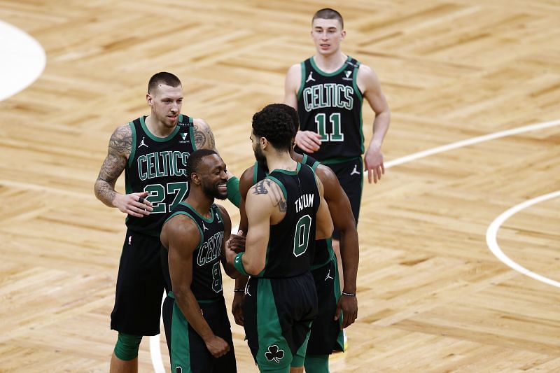 Jayson Tatum #0 celebrates with Kemba Walker #8