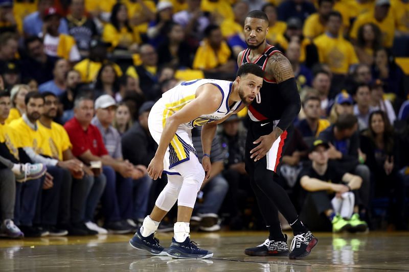 Stephen Curry #30 of the Golden State Warriors and Damian Lillard #0 of the Portland Trail Blazers