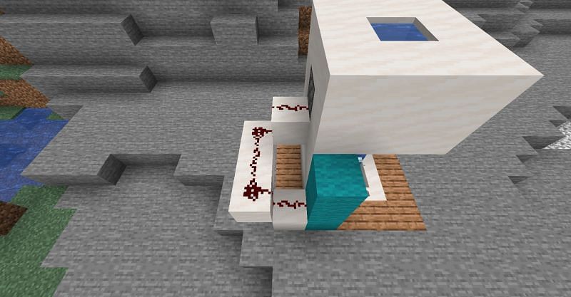 Adding some extra blocks, redstone, piston, and water to the Minecraft shower. (Image via Minecraft)