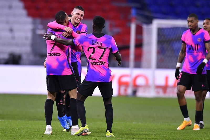 PSG players celebrate after scoring a goal against Lyon.