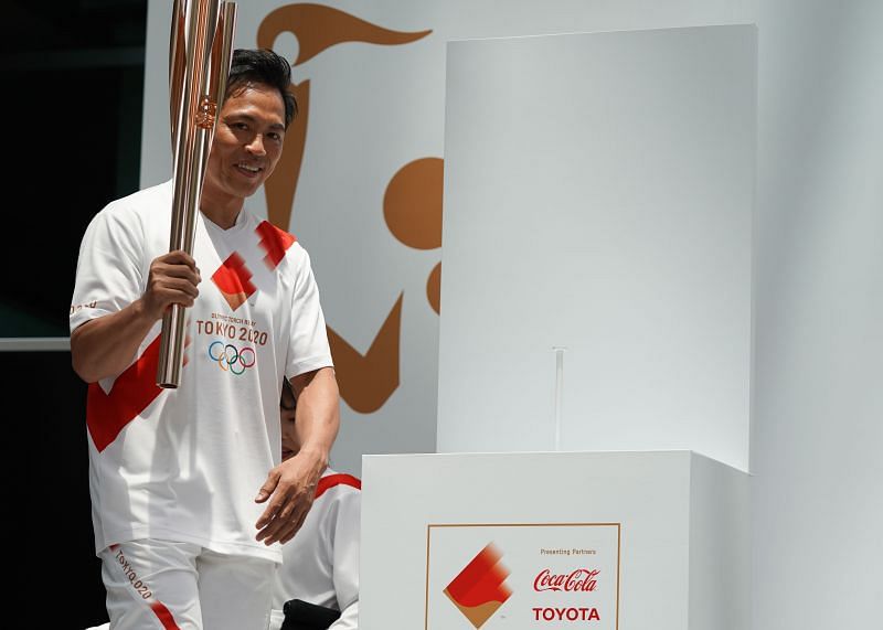 Tokyo 2020 Torch Relay Official Ambassador Tadahiro Nomura with the Olympic Games torch in June 2019 in Tokyo, Japan