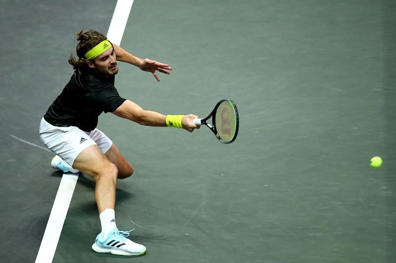 Stefanos Tsitsipas retrieves a ball