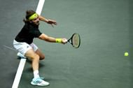 Stefanos Tsitsipas retrieves a ball