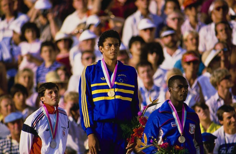 Joaquim Cruz stands on the podium with his gold medal alongside silver medallist Sebastian Coe and bronze medallist Earl Jones after winning the final of the Men&#039;s 800 metres event at the 1984 Summer Olympics