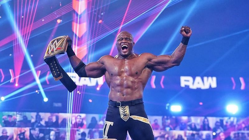 Bobby Lashley posing with the WWE Title a week before winning it