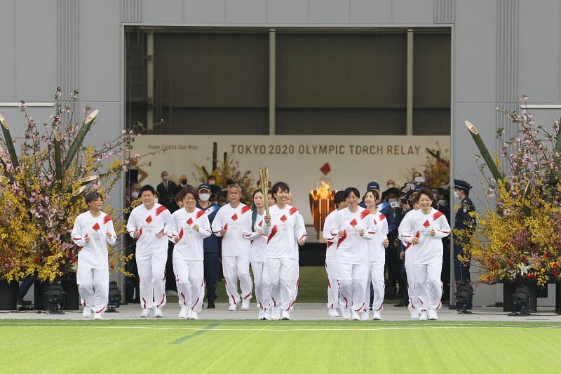 Azusa Iwashimizu (C) and other members of Japan women&#039;s National Football Team during the Olympic Torch Relay for Tokyo Olympic Games on March 25, 2021, in Fukushima, Japan