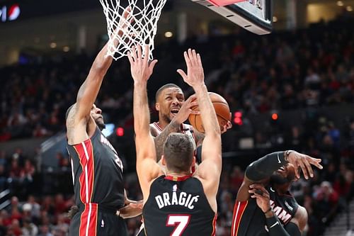 Damian Lillard #0 takes a shot against three players (Photo by Abbie Parr/Getty Images)