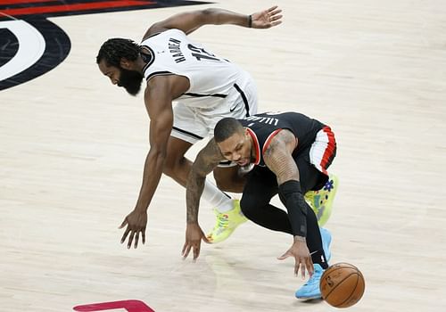 Damian Lillard #0 is pressured by James Harden #13. Photo: Steph Chambers/Getty Images.