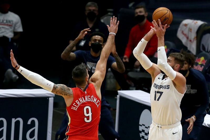 Memphis Grizzlies center Jonas Valanciunas (right) scores against the New Orleans Pelicans.