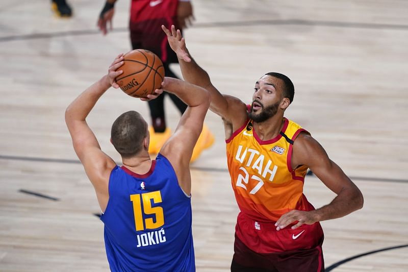 Rudy Gobert #27 of the Utah Jazz defends against Nikola Jokic #15 of the Denver Nuggets.