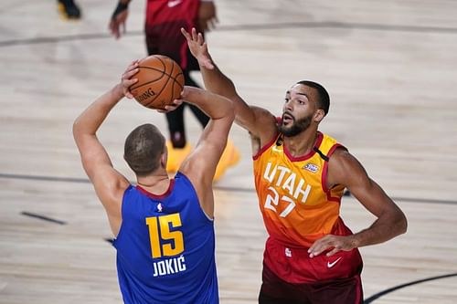 Rudy Gobert #27 of the Utah Jazz defends against Nikola Jokic #15 of the Denver Nuggets.