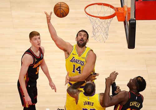 Marc Gasol #14 attacks the basket against Kevin Huerter #3