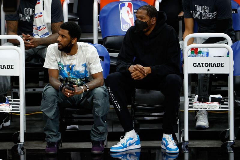 Kyrie Irving #11 and Kevin Durant #7 of the Brooklyn Nets watch from the bench during the first half of the NBA game against the Phoenix Suns. (Photo by Christian Petersen/Getty Images)