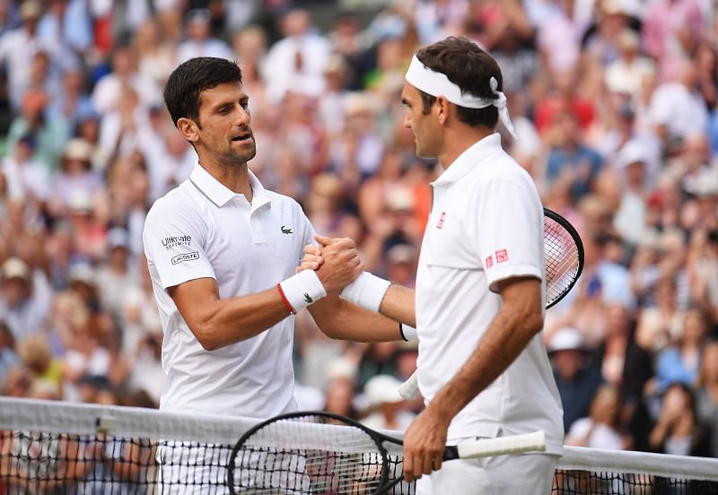 Novak Djokovic shakes hands with Roger Federer following the men&#039;s singles final at Wimbledon 2019