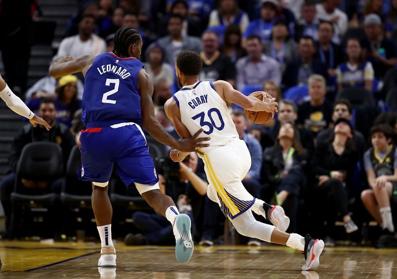 Stephen Curry (#30) of the Golden State Warriors is guarded by Kawhi Leonard (#2) of the LA Clippers.