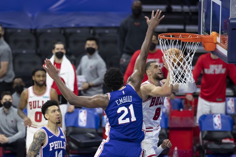 Zach LaVine (#8 )of the Chicago Bulls shoots the ball against Joel Embiid (#21) of the Philadelphia 76ers.