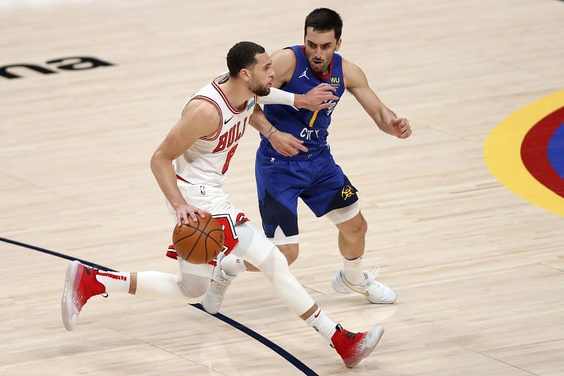 Facundo Campazzo #7 guards Zach LaVine #8. Photo: Matthew Stockman/Getty Images.