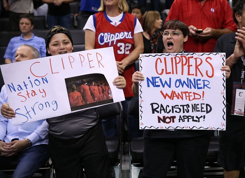 LA Clippers fans hold up placards about Donald Sterling.
