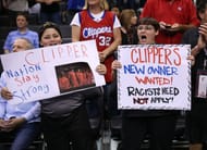 LA Clippers fans hold up placards about Donald Sterling.