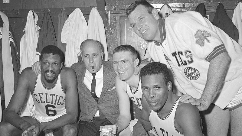 Bill Russell, coach Red Auerbach and the Boston Celtics celebrate one of their NBA titles.
