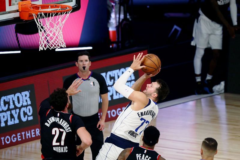 Luka Doncic #77 of the Dallas Mavericks shoots the ball against Jusuf Nurkic #27 of the Portland Trail Blazers