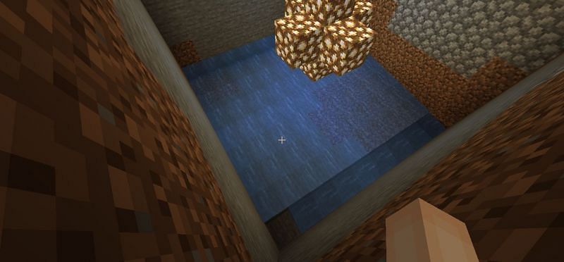 The hole filled with water (Image via Minecraft)