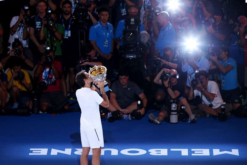 Roger Federer poses with the men's singles trophy at the 2018 Australian Open