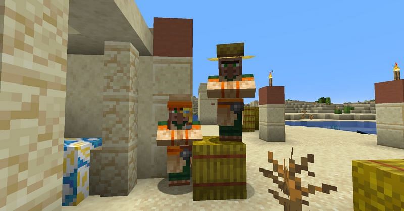 Two Minecraft villagers in a desert village. (Image via Minecraft)