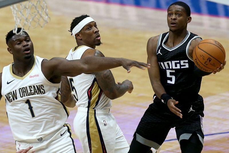 De&#039;Aaron Fox #5 of the Sacramento Kings drives to the basket against Eric Bledsoe #5 and Zion Williamson #1 of the New Orleans Pelicans. (Photo by Sean Gardner/Getty Images)