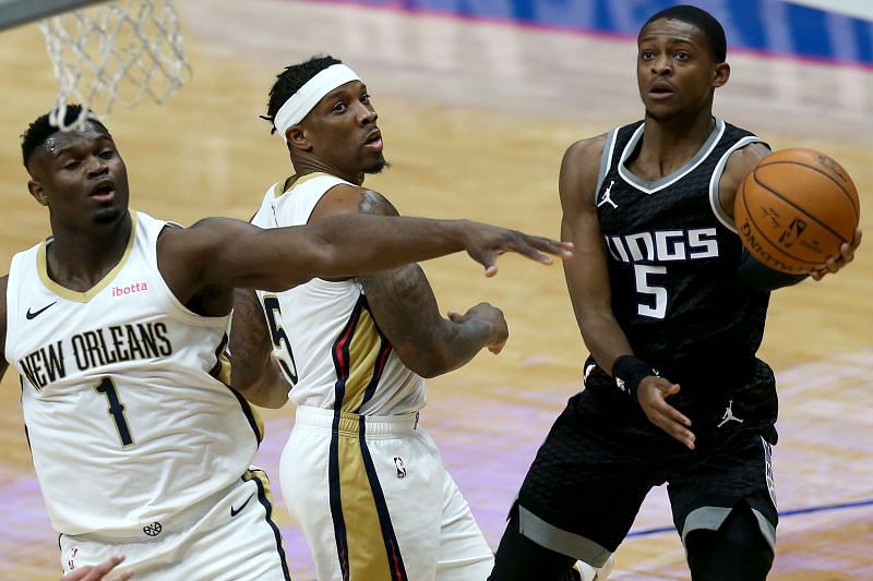 De'Aaron Fox #5 of the Sacramento Kings drives to the basket against Eric Bledsoe #5 and Zion Williamson #1 of the New Orleans Pelicans. (Photo by Sean Gardner/Getty Images)