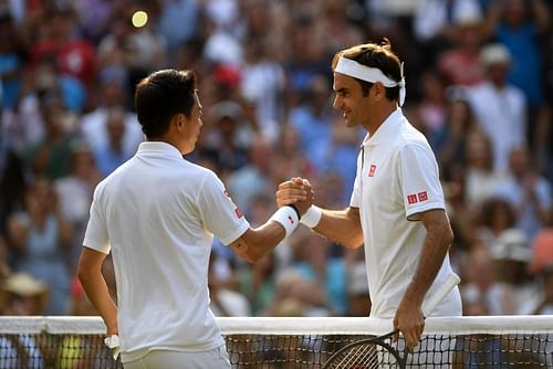 Roger Federer shakes hands with Kei Nishikori at Wimbledon 2019