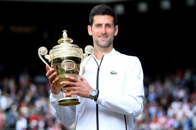Novak Djokovic poses with the Wimbledon trophy in 2019