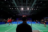 A badminton doubles match in progress